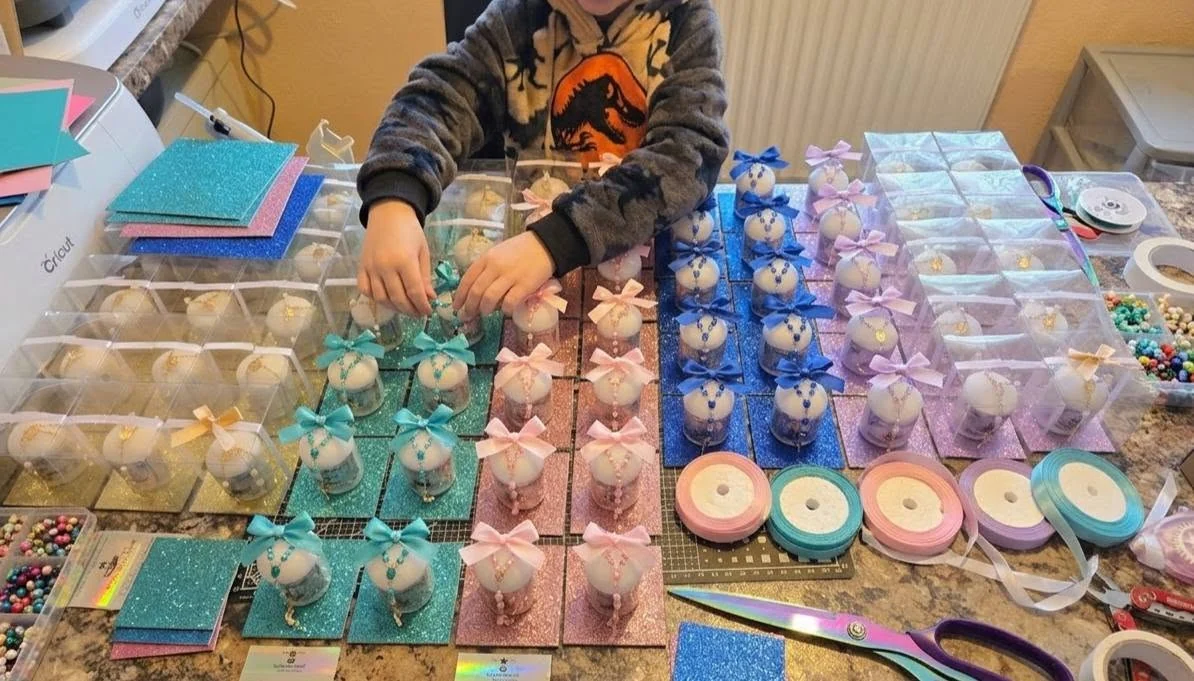 A child helping with colourful handmade gift packaging