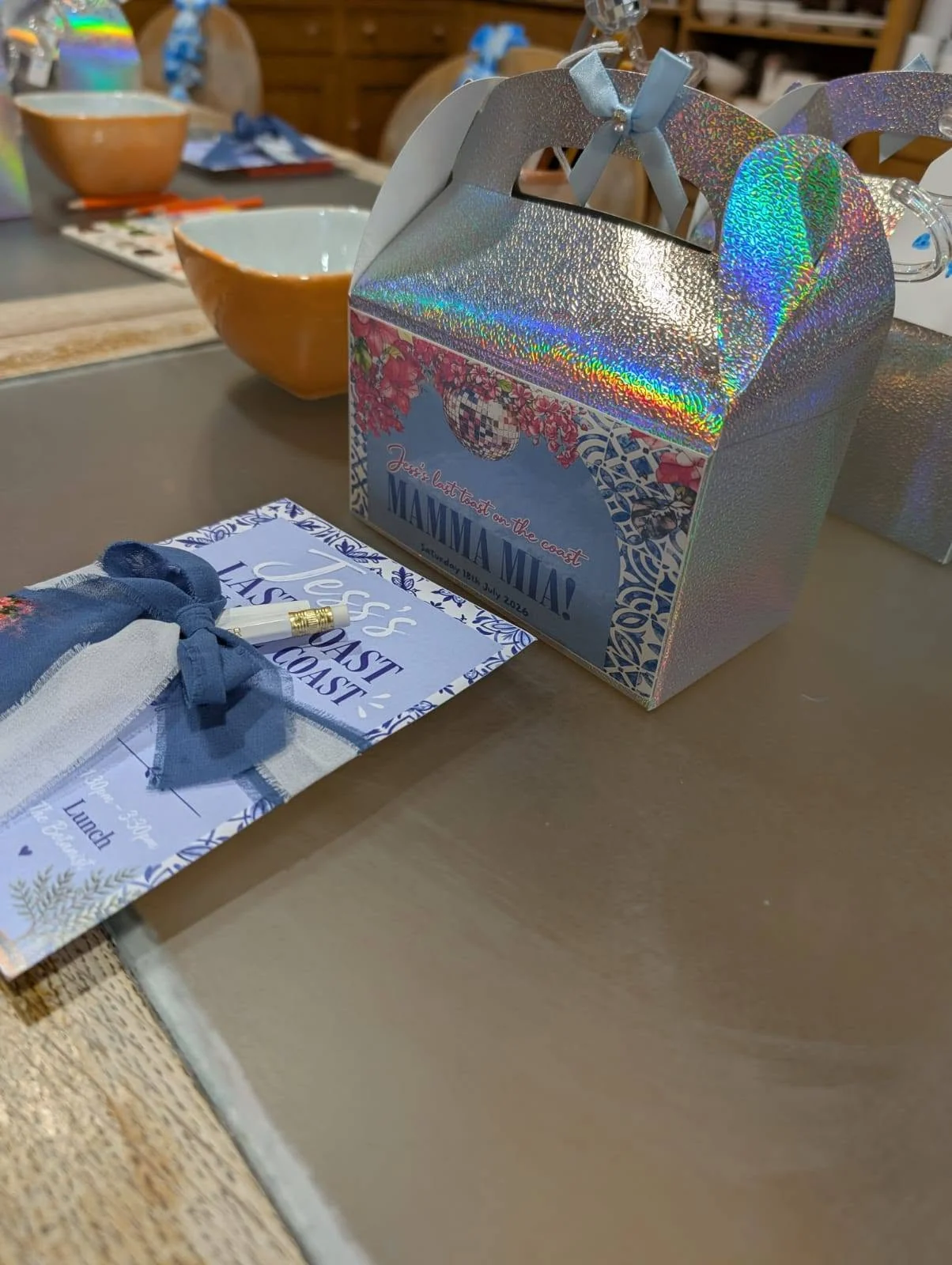 Close-up photo of a holographic gift box and matching stationery